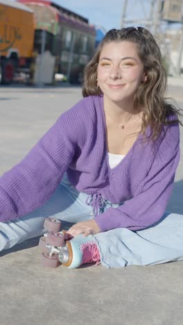 young woman with roller skates sitting outdoors on a sunny day