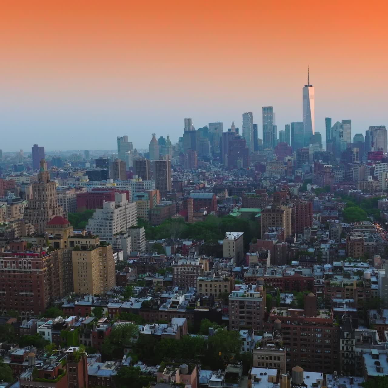Diverse buildings of New York downtown at sunset. Beautiful skyscrapers towering at backdrop. Amazing pink sky background