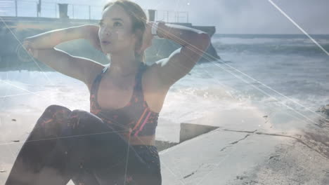 network of connections against caucasian woman performing abs exercise at the beach