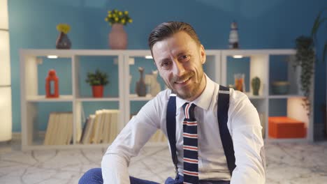 stylish handsome man looking at camera and smiling at modern home.