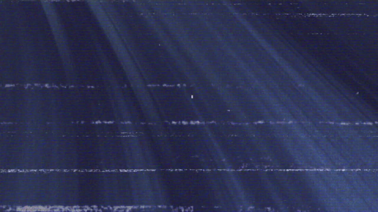 Glitch causing static, shifting scanlines and diagonal rays sweeping left, simulating signal error