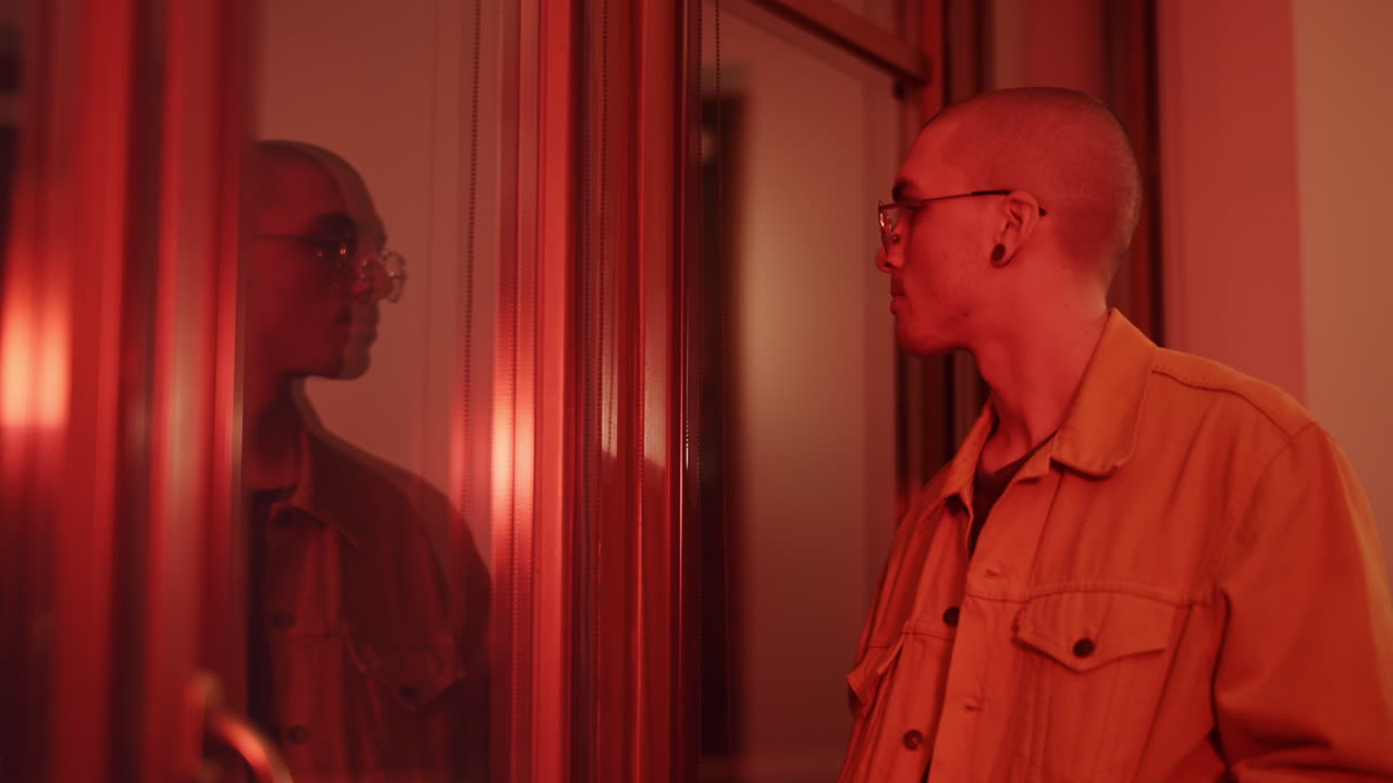 Man Reflecting in Red Lit Room