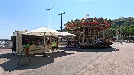 a carousel spinning near monte carlo harbor