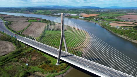 drone circling establishing shot of the thomas francis meagher bridge spanning the river suir impressive transport infrastructure in south east ireland