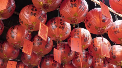 Slow-motion-shot-of-red-Chinese-paper-lanterns-with-symbols