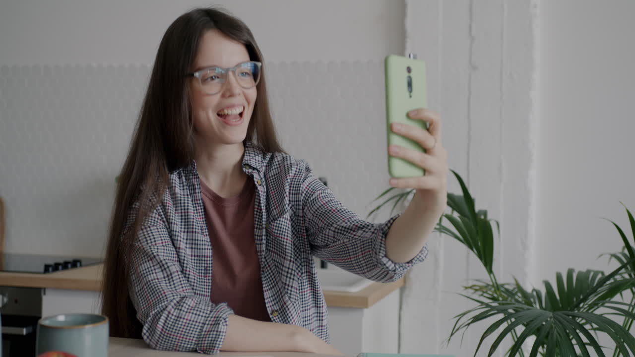 Woman taking a selfie in her kitchen