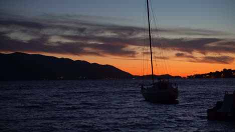 small sail boat gently rolling in the calm ocean at sunset in croatia