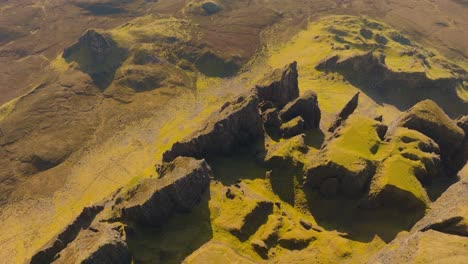 aerial drone footage of the dramatic mountain landscapes on the isle of skye, scotland. sweeping panoramic views of majestic peaks, green valleys, and wild nature. quiraing walk