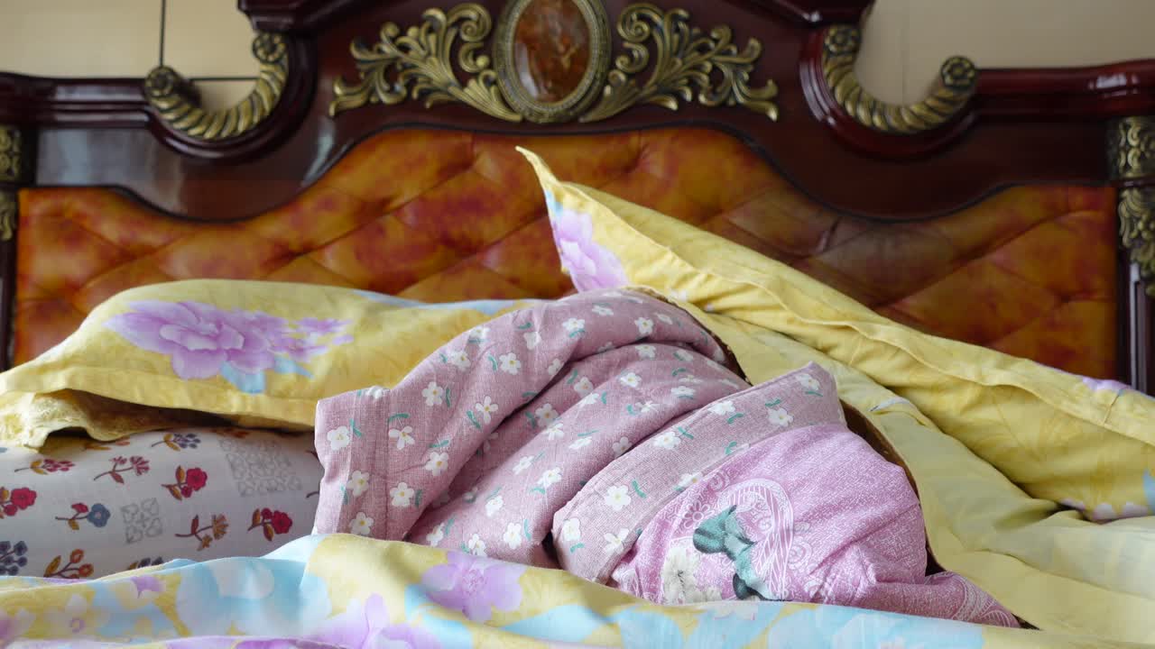 A bed with floral bedding and pillows
