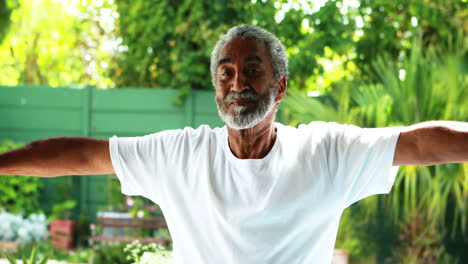 Senior-man-exercising-with-dumbbell-at-home