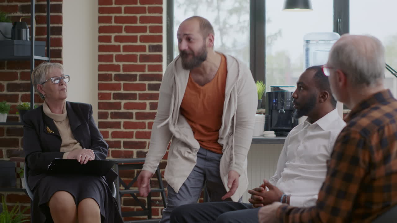 Alcohol addict with desperate behavior having breakdown at aa therapy meeting