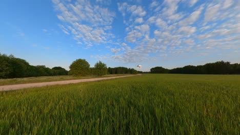 Zeitlupen-Weitwinkelaufnahme-Einer-Drohne,-Die-Tief-über-Einem-Landwirtschaftlichen-Feld-Fliegt