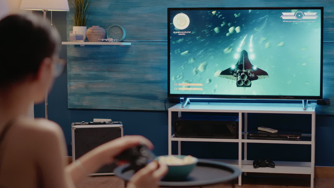 Young woman playing action video games on console