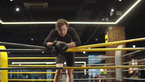 relaxed sport man having break at gym. fit man looking at camera in sport club