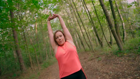 Caucasian-woman-doing-exercise-and-hands-stretching-on-warming-up-at-outdoor-workout-in-summer-park