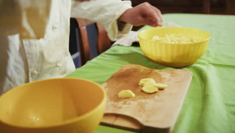 private man chef cuts food potatoes on a cutting board