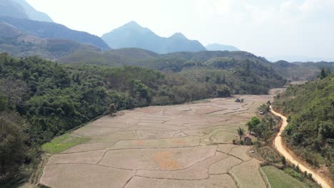 drone shot of farm fields in the mountain town of nong khiaw in laos, southeast asia