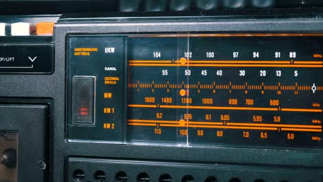 tuning analog radio dial frequency on scale of the vintage receiver