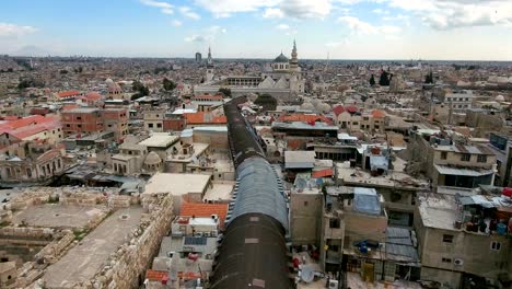 beautiful panoramic view of the umayyad mosque in syria. drone is flying over the city of damascus to the religious mosque.