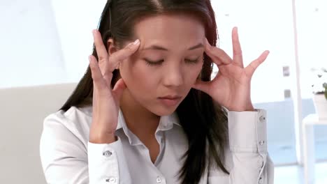 businesswoman feeling stressed at her desk