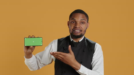 Waiter-with-professionalism-holding-a-phone-with-isolated-mockup-display