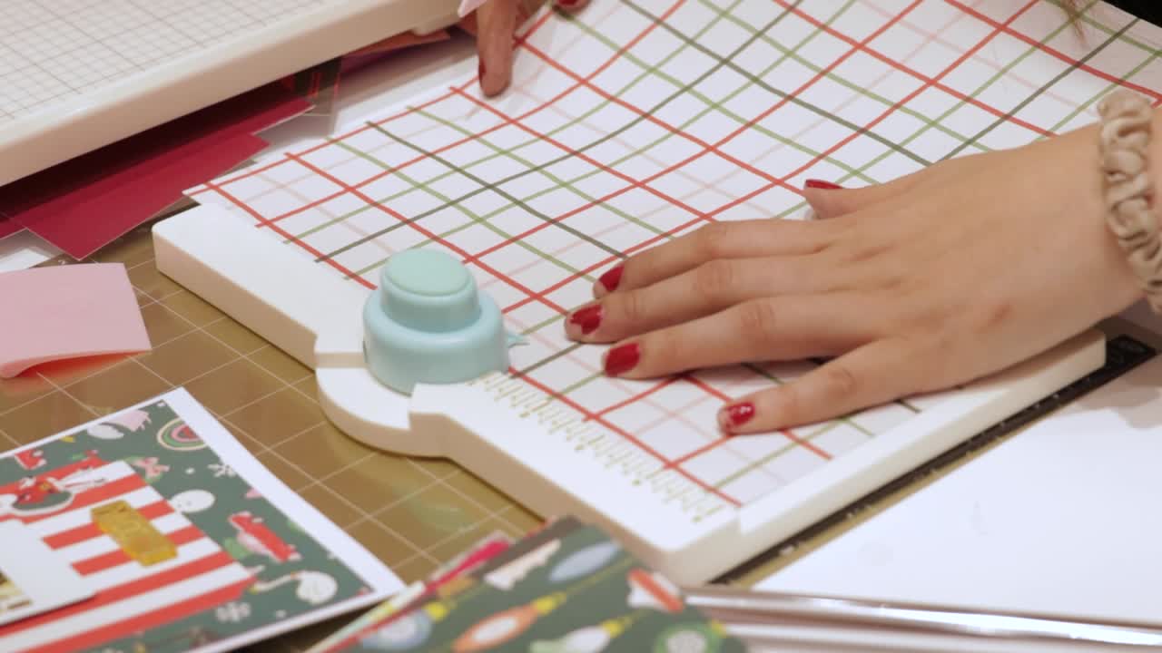 Woman crafting with paper punches and patterned paper