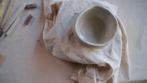 pottery workshop with clay bowl and tools