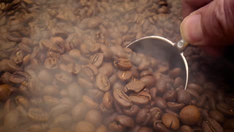 close up of seeds of coffee. fragrant coffee beans are roasted smoke comes from coffee beans.