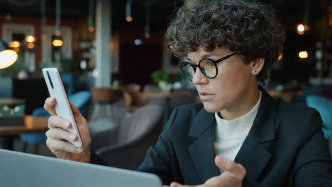 business woman using smartphone in cafe
