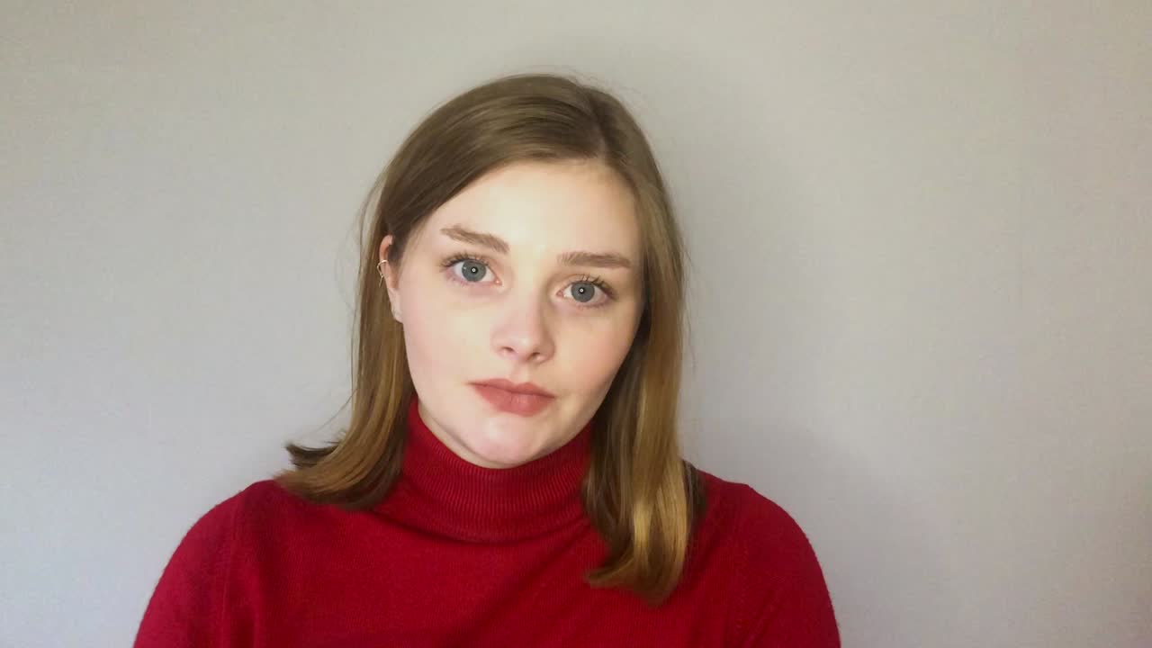 이야기하고 카메라에 직접 유리를 올리는 여성 젊은 학생