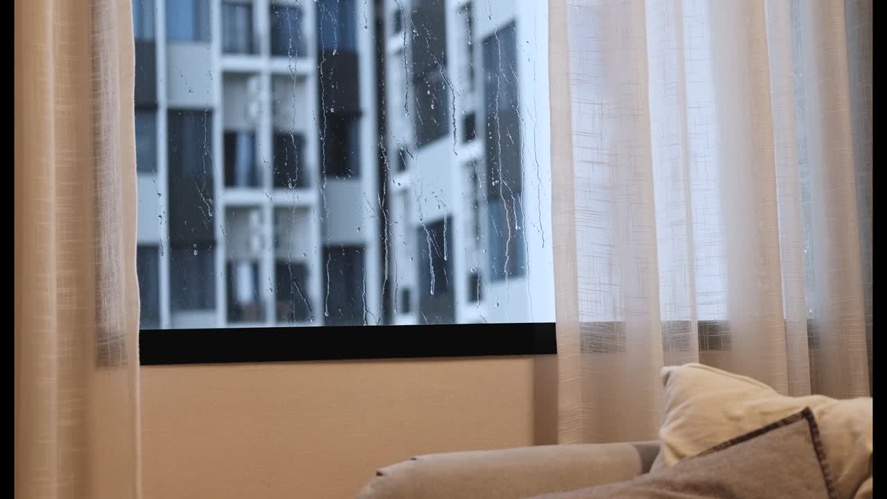 The rain was falling and water splashed on the window. with sheer curtains beside 4k