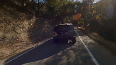 Cinematic-FPV-drone-chasing-shot-of-a-police-car-driving-down-a-country-road