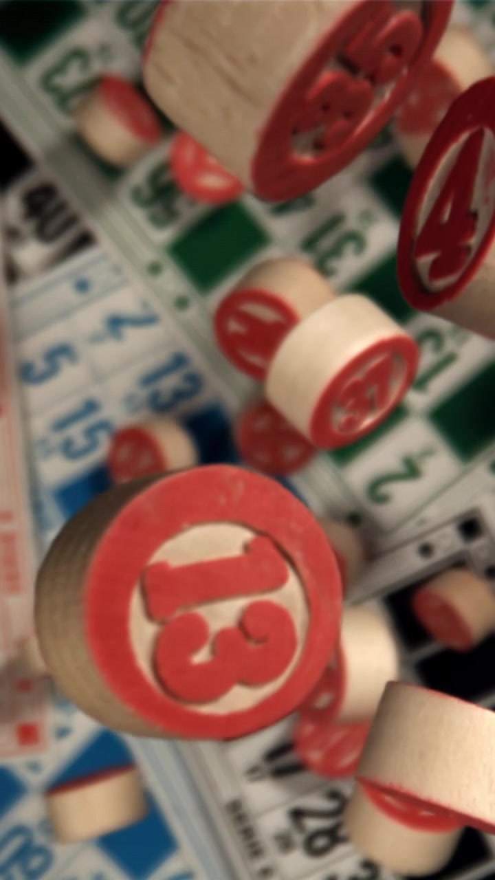 Fiches da bingo rosse numerate che cadono sulle cartelle da gioco