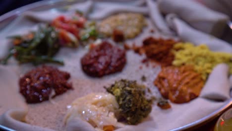 rack focus on ethiopian african injera food on a silver tray