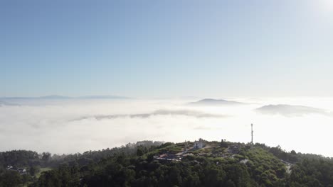 aerial view of a hilltop with fog and mountains