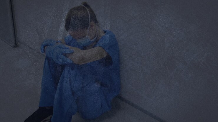 Textured scratched overlay against stressed caucasian female health worker sitting at hospital