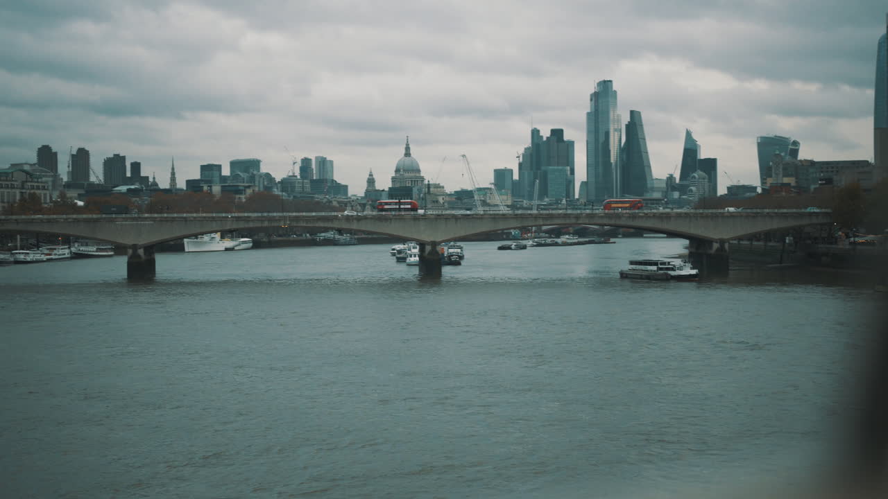 Slider shot of Waterloo Bridge over the River Thames with London city skyline in the background