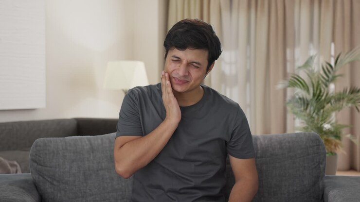 Sick Indian man suffering from tooth pain