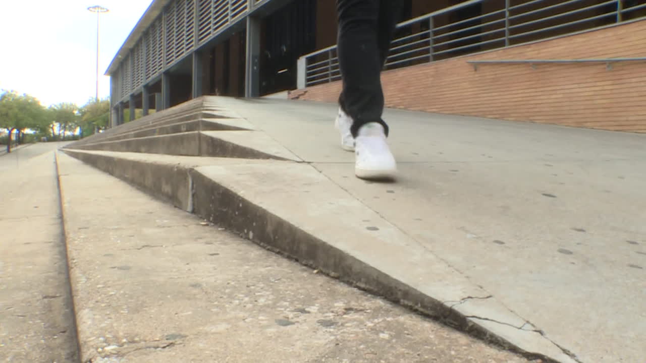 Person Walking Up Ramp at Building Exterior