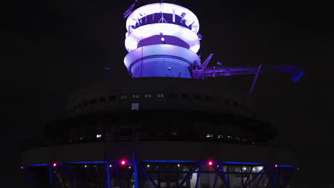 aerial view rising around the illuminated kuala lumpur tower, night in malaysia