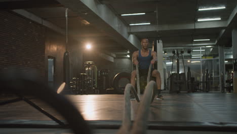 Lower-view-of-an-athletic-african-american-man-in-the-gym.