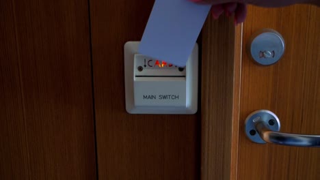 Slow-motion-shot-of-putting-a-hotel-card-into-hotel-room-electricity-activation