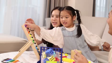 a family enjoys playing educational games together in a cozy living room, fostering learning and connection