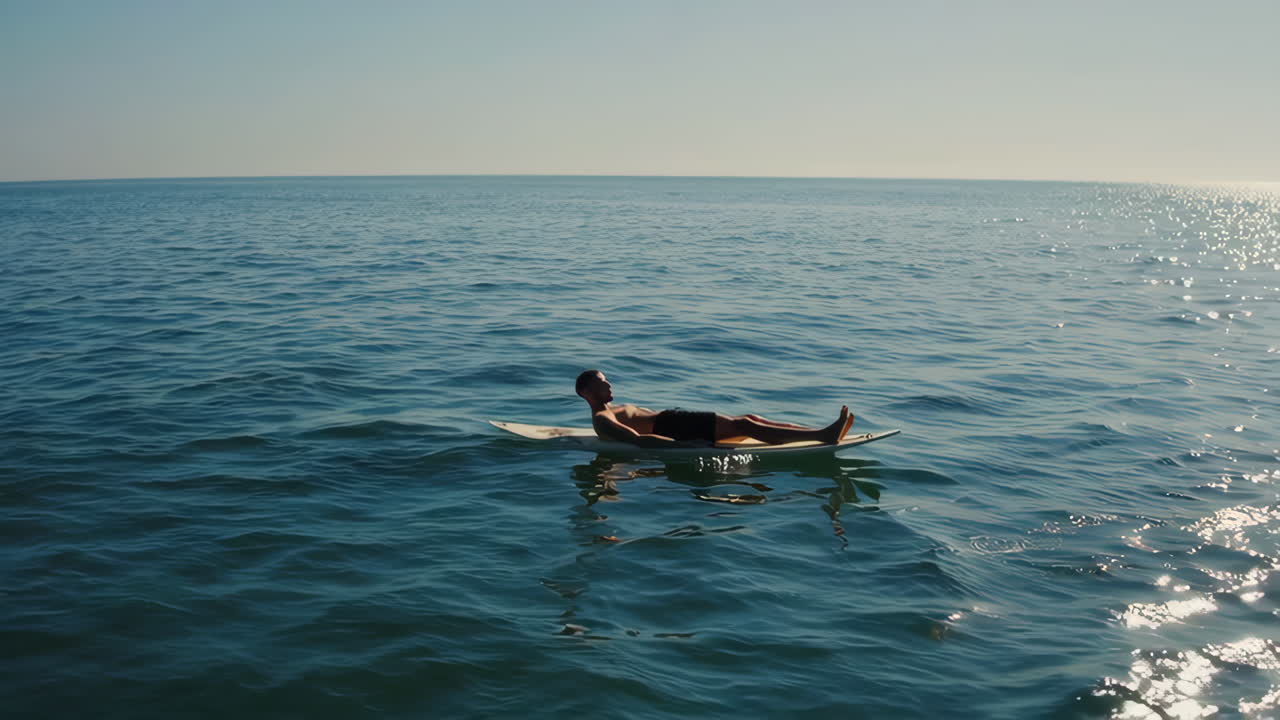Man Enjoying Paddleboarding in the Calm Ocean