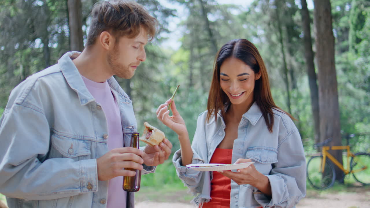 Couple friends eating picnic summer day closeup. Smiling woman