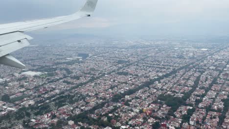 shot from the window of the plane during the landing over the areas surrounding the city of mexico