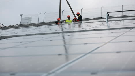 alternative energy from nature. vinnitsa, ukraine - november 2017: electrical engineers installing photovoltaic plant in solar power station