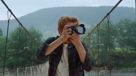 photographer enjoy mountains nature closeup. joyful tourist take photo on camera