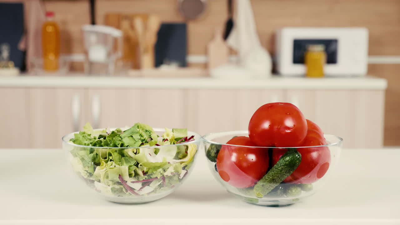 Salad and tomatoes on kitchen counter