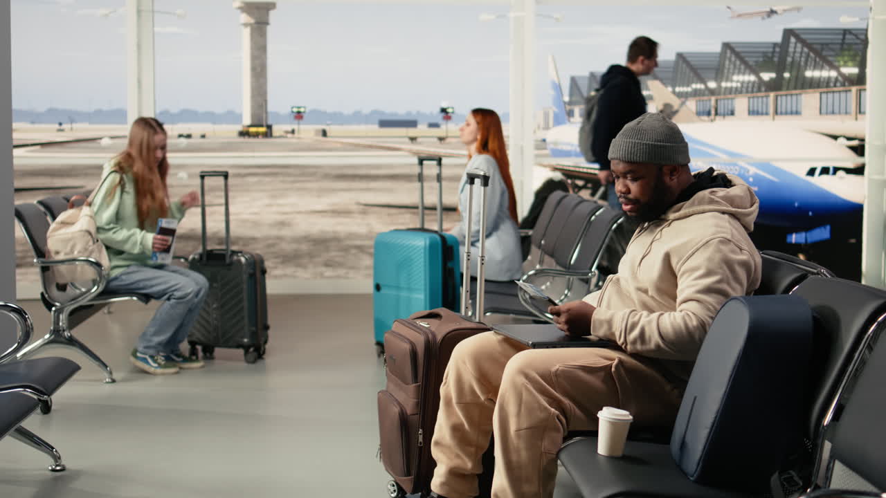 Black digital nomad checking boarding pass with smartphone on app